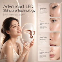 Woman holding LED light therapy mask during skincare routine